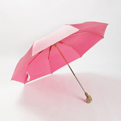 Pink luxury folding umbrella with crystal skull handle