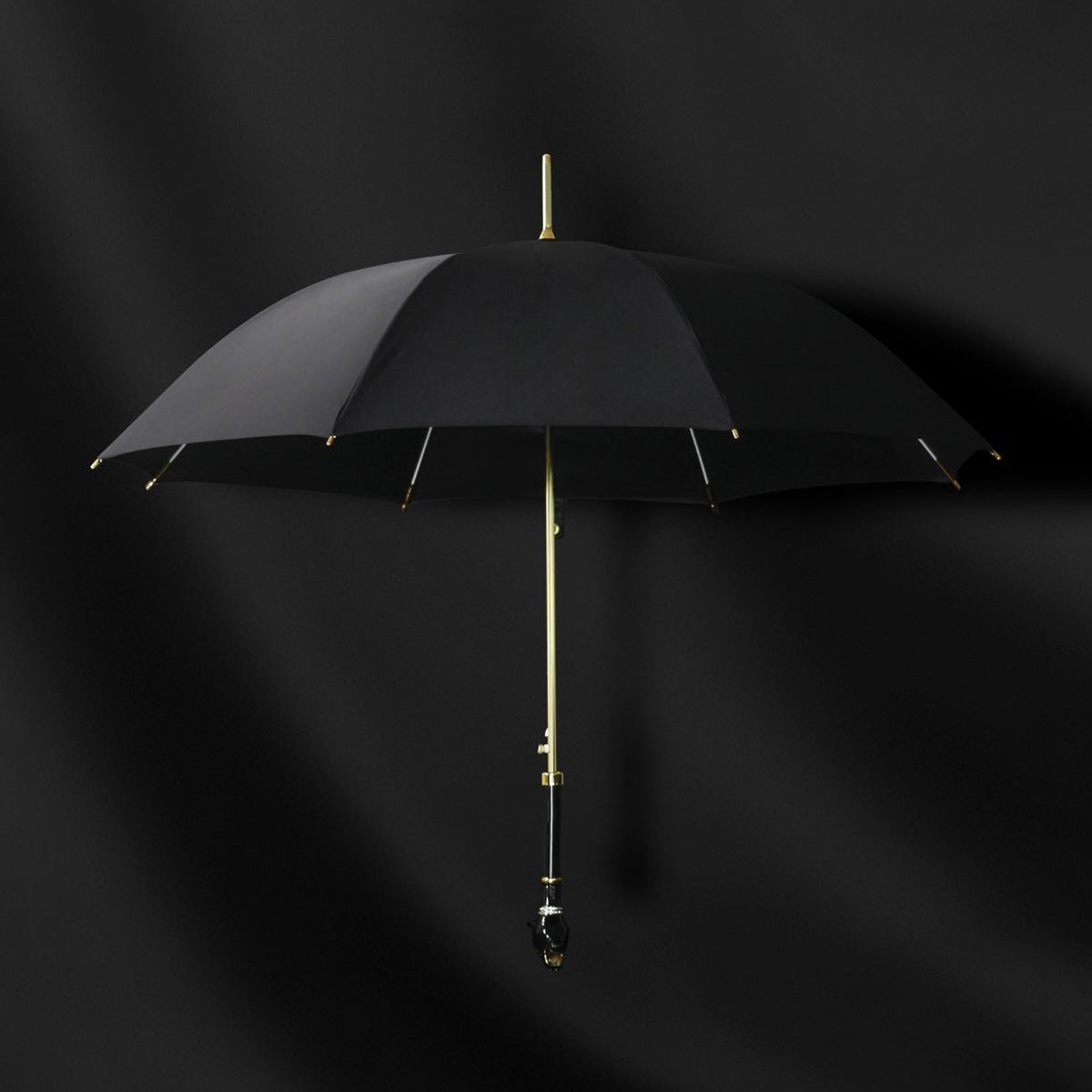 Elegant Black Umbrella with Gold Accents open against dark background