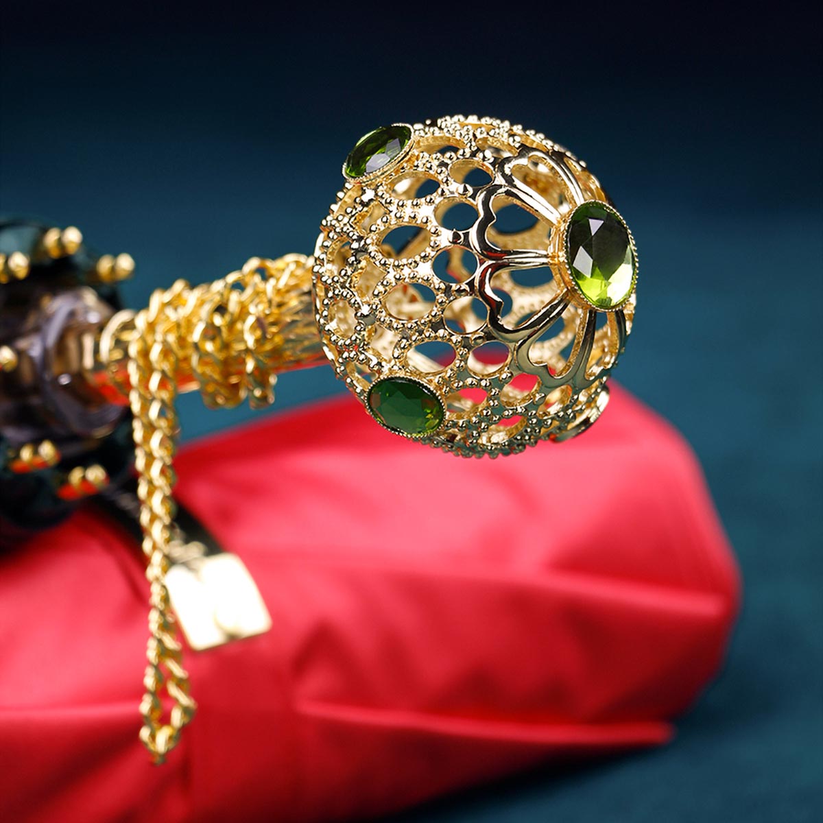 Gold filigree crystal ball handle with green gemstones, designer umbrella luxury detail shot