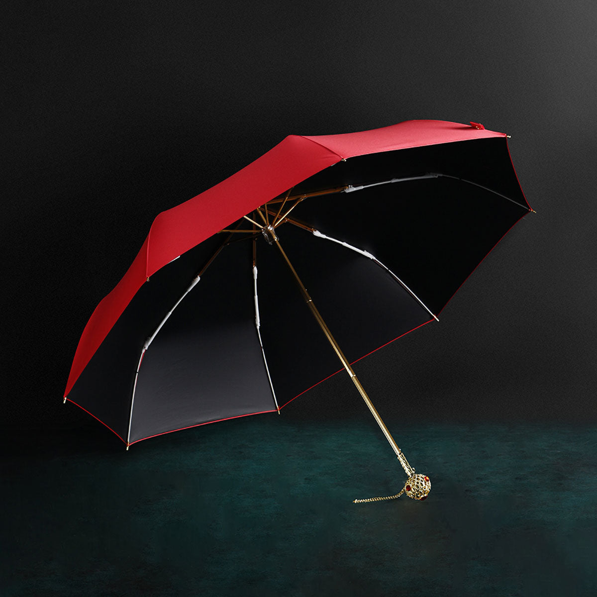 Prestige umbrella fully opened showing red premium fabric, gold crystal handle and 8-panel construction