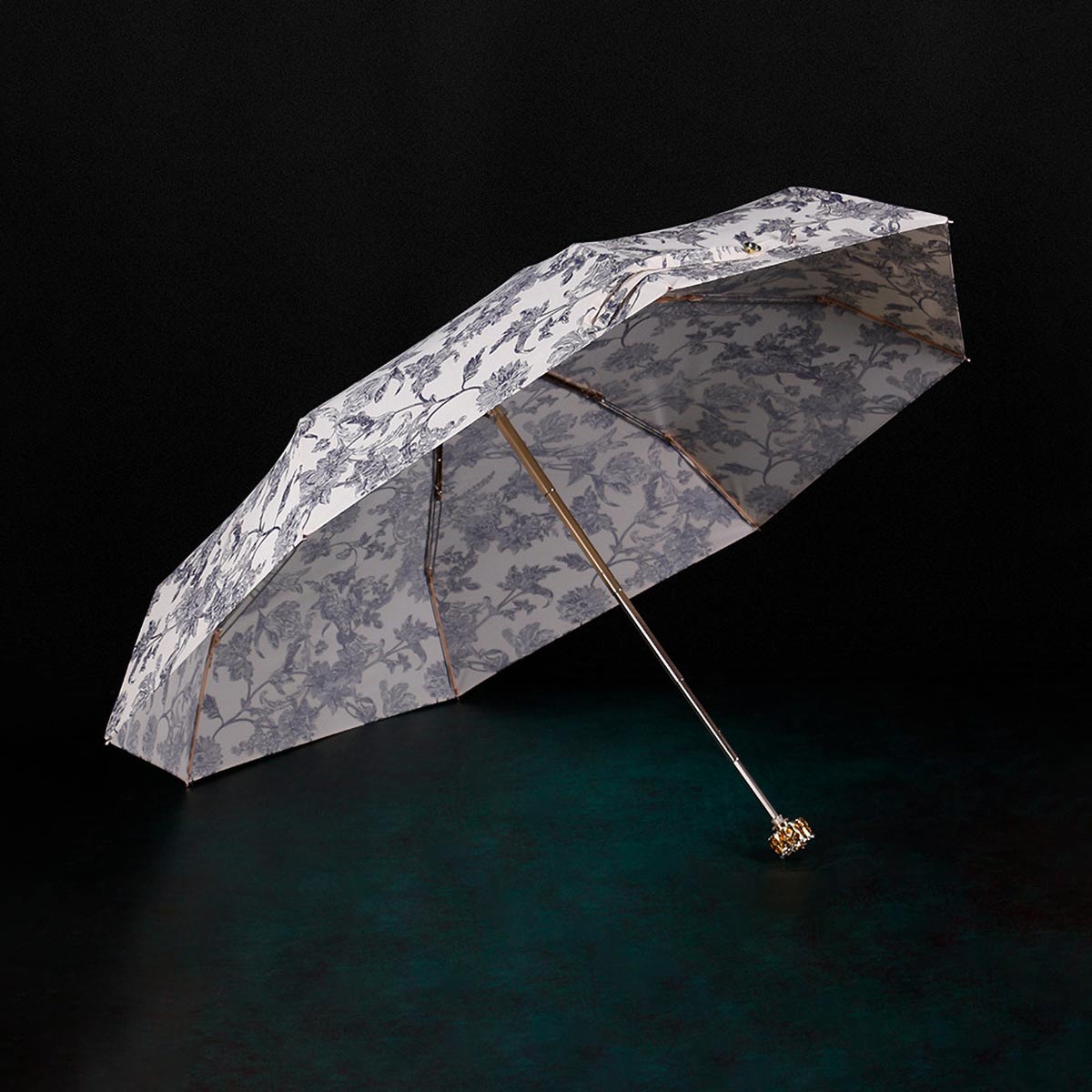 Open small floral umbrella displaying luxurious design for women