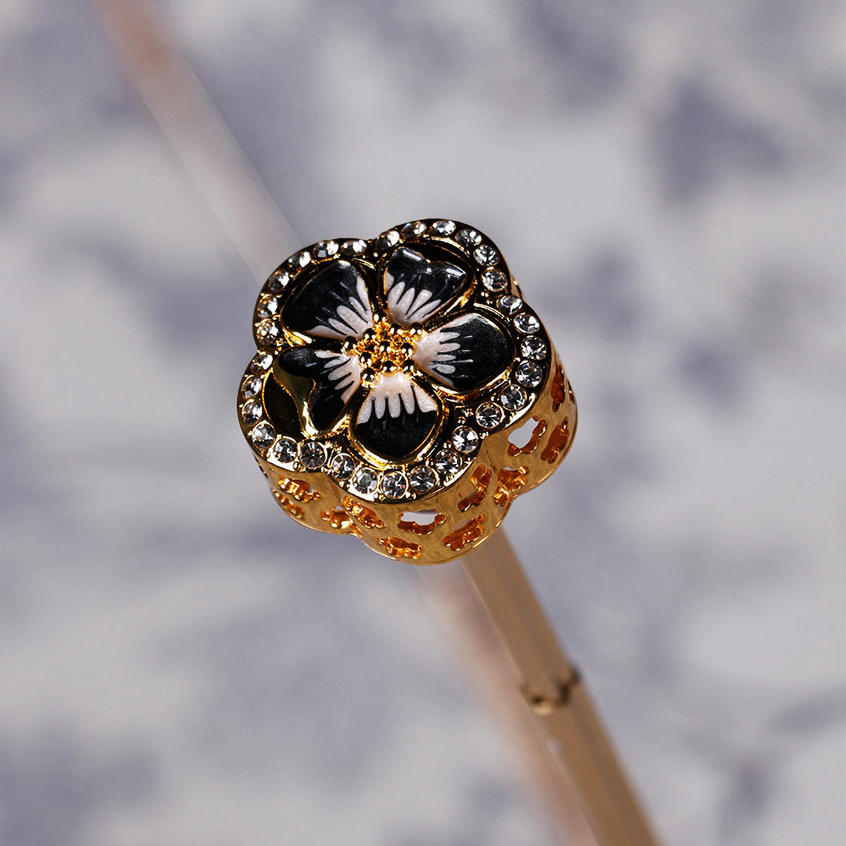 Close-up of gold crystal flower handle on luxury umbrella